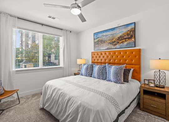 A bedroom with a large bed, a ceiling fan, and a painting on the wall. at Aurora Watson Branch, Texas, 76063