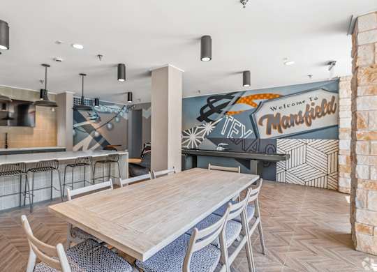 A room with a wooden table and chairs and a mural on the wall. at Aurora Watson Branch, Texas, 76063