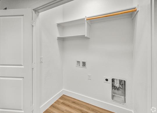 A white room with a door and a shelf. at Aurora Watson Branch, Mansfield, 76063