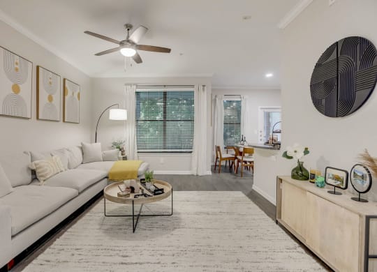 a living room with a white couch and a ceiling fan at The Vista on Brodie, Texas, 78745