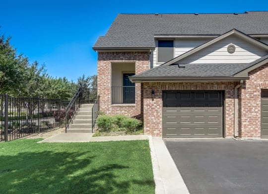 a house with a driveway and a garage door in front of it  at The Vista on Brodie, Austin, TX