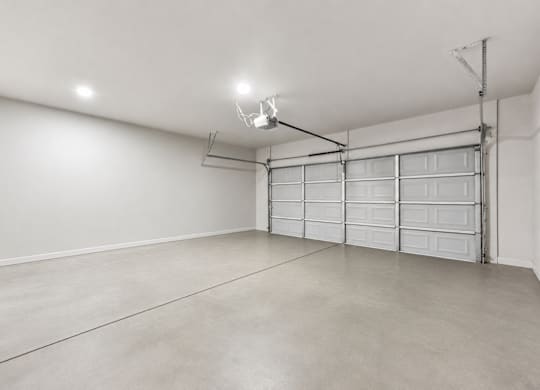 A spacious garage with a white wall and a white ceiling.