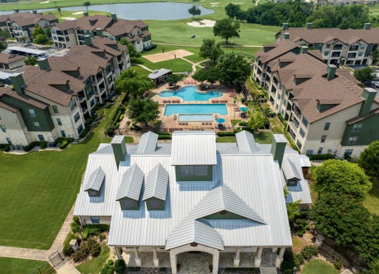 an aerial view of an apartment complex with a swimming pool
