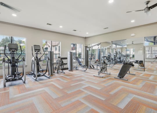 fitness center with weights and cardio equipment