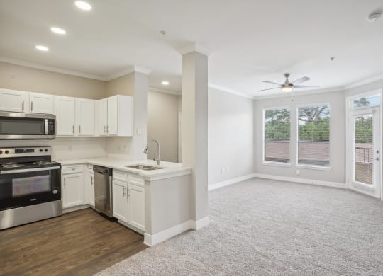 an empty kitchen and living room with a ceiling fan  at The Verandah, Austin, Texas
