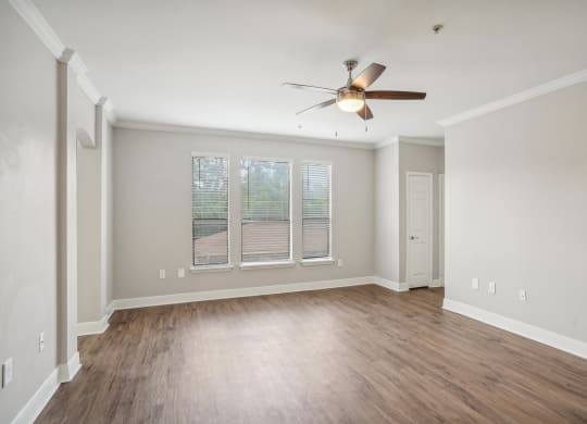 an empty living room with a ceiling fan and a window  at The Verandah, Austin, TX, 78726