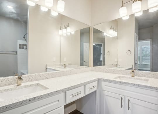 a large bathroom with two sinks and two mirrors at The Verandah, Austin, TX, 78726