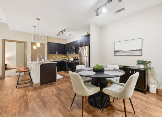 a dining room and kitchen with a table and chairs at Lakeline East Apartments, Cedar Park, TX