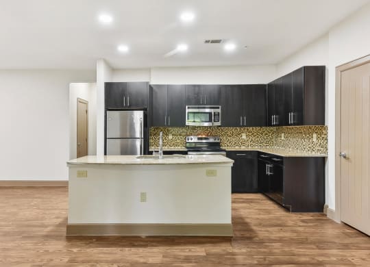 a large kitchen with a large island in the middle of it at Lakeline East Apartments, Cedar Park, 78613