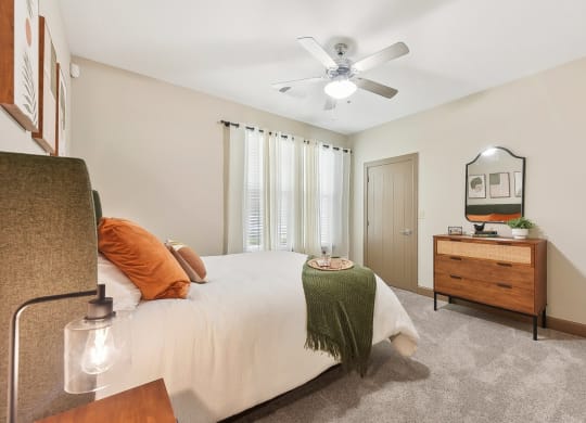 a bedroom with a bed and a ceiling fan at Lakeline East Apartments, Texas, 78613