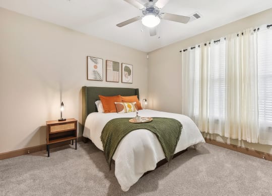 a bedroom with a bed and a ceiling fan at Lakeline East Apartments, Cedar Park