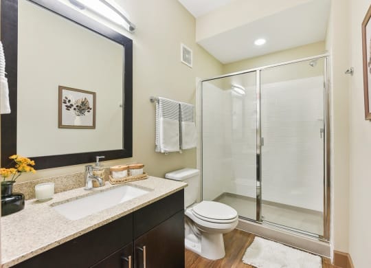 a bathroom with a shower toilet sink and mirror at Lakeline East Apartments, Cedar Park, 78613
