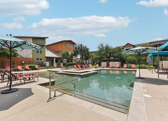 a view of a water park with a pool and buildings at Lakeline East Apartments, Cedar Park