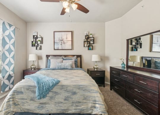 a bedroom with a bed and a ceiling fan