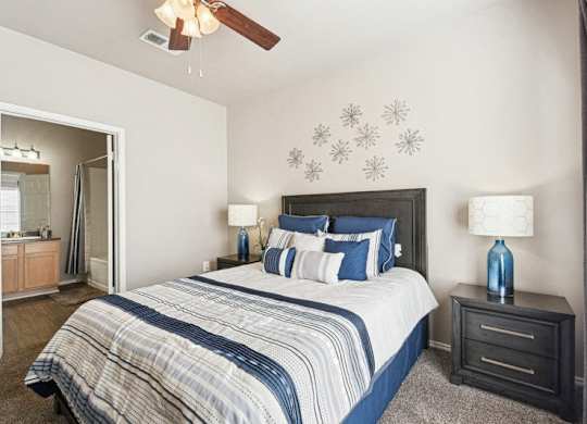 a bedroom with a bed and a ceiling fan