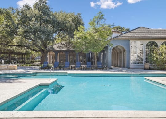 a swimming pool with a house in the background