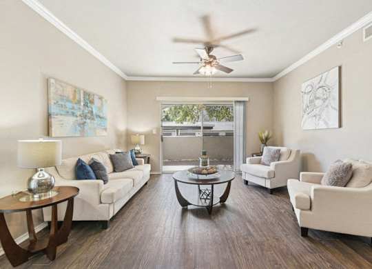 a living room with furniture and a ceiling fan