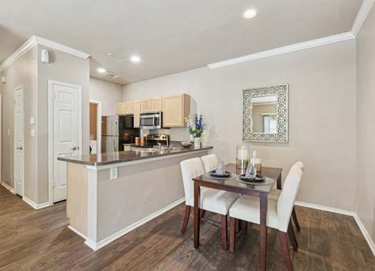 a dining room and kitchen with a table and chairs