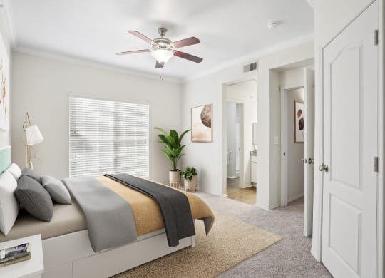 a bedroom with a bed and a ceiling fan at La Ventura Apartments, Texas, 75093