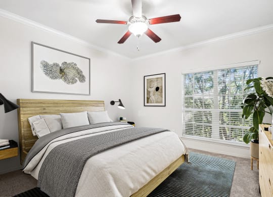 a bedroom with a bed and a ceiling fan at La Ventura Apartments, Texas, 75093