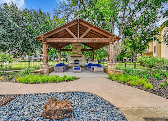 A gazebo is surrounded by a gravel area and a paved walkway. at The Canyons Apartments, Texas