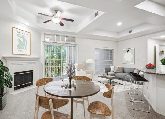 a living room with a table and chairs and a fireplace at La Ventura Apartments, Plano, 75093
