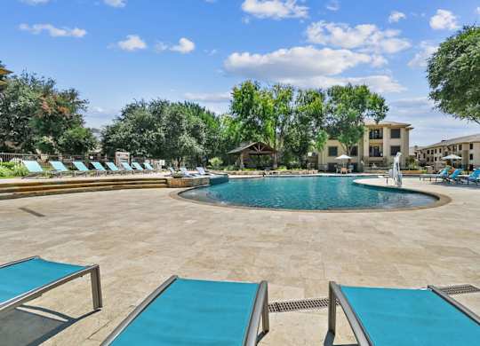 Pool With Relaxing Chairs at The Canyons Apartments, Fort Worth, TX, 76116