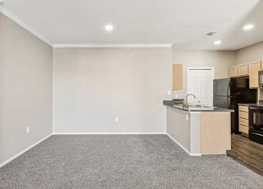 an empty room with a kitchen and a counter top in it