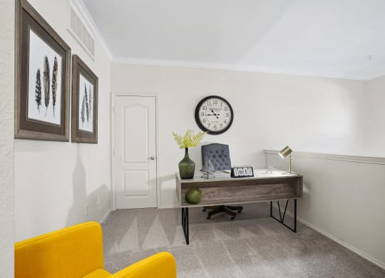 a home office with a desk and a clock on the wall at La Ventura Apartments, Plano, TX, 75093