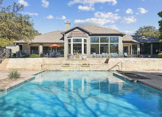 a pool with a house in the background