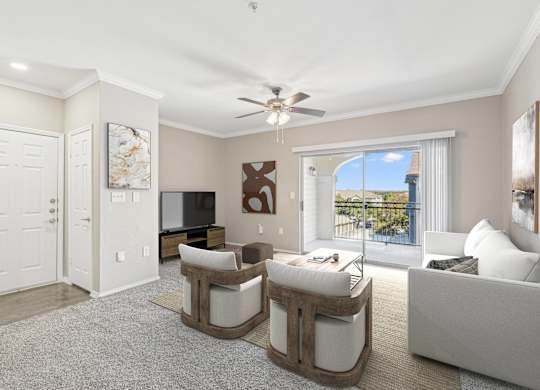 a living room with white furniture and a ceiling fan