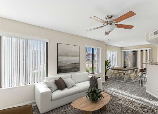 A living room with a white couch, a brown coffee table, and a ceiling fan. at San Montego Apartments, Arizona, 85206