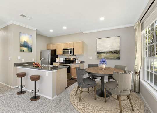 a living room with a kitchen and a dining area with a table and chairs