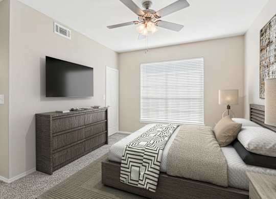a bedroom with a large bed and a ceiling fan