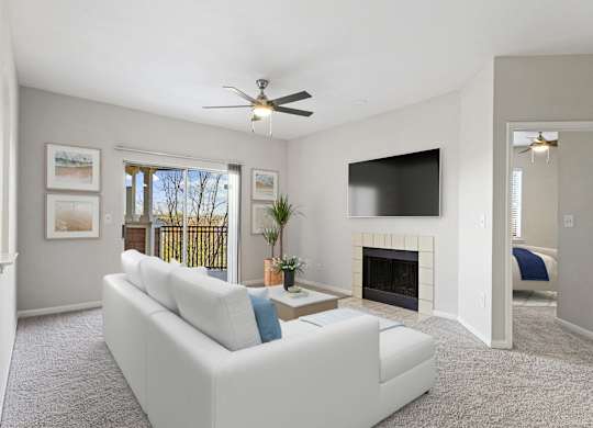 a living room with a white couch and a ceiling fan at The Legends at Eagle Mountain Lake, Fort Worth, Texas