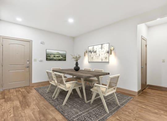 a dining room with a wooden table and chairs  at Lakeline East Apartments, Cedar Park, TX, 78613