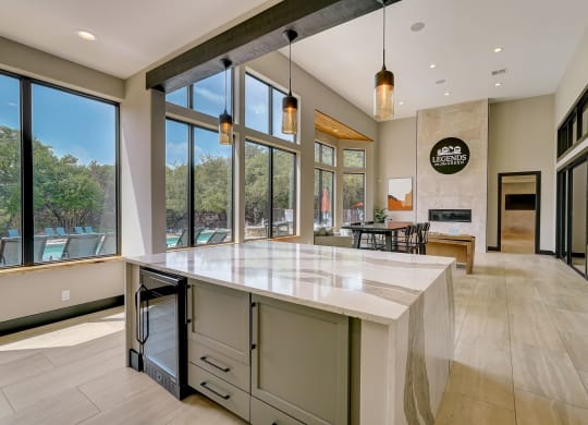 a large kitchen with a large island and large windows
