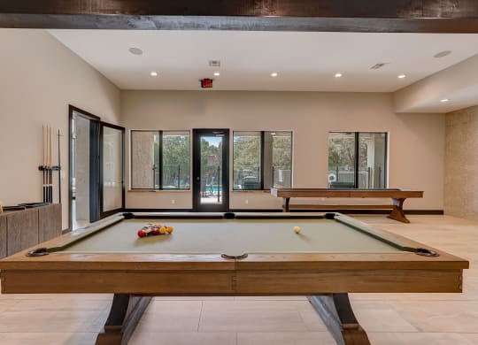 pool table in the clubhouse of a house with two pool tables