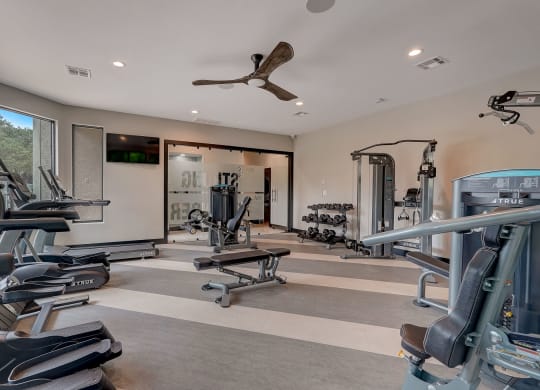 a gym with weights and cardio equipment in a home for sale