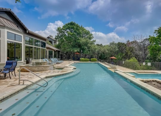 a swimming pool with a house in the background