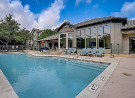 the preserve at ballantyne commons pool with chairs and a building with a pool