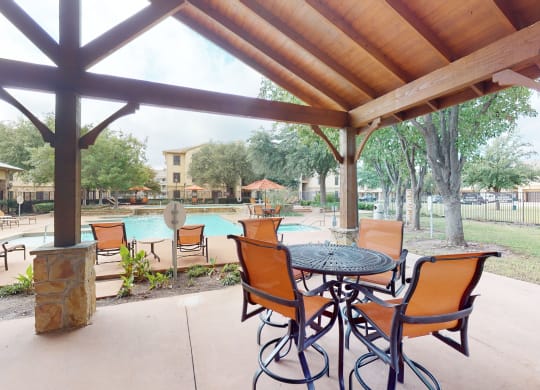 Outdoor lounge and poolside seating at The Canyons Apartments, Fort Worth, 76116