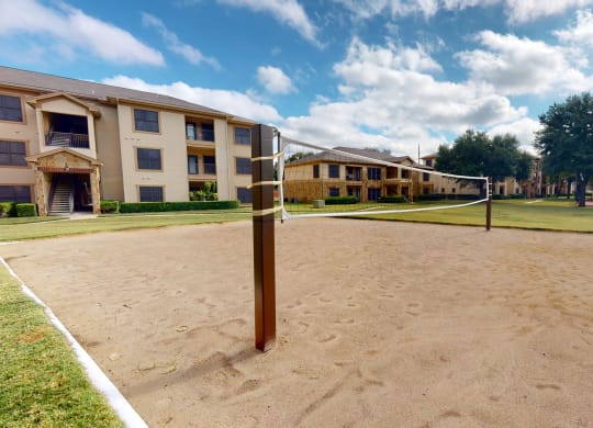 outdoor sand volleyball court at The Canyons Apartments, Fort Worth, 76116