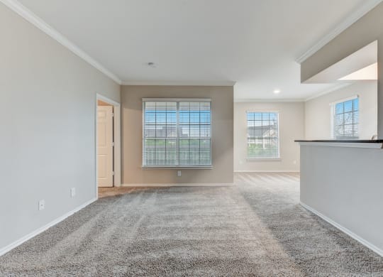 the spacious living room and dining room in a new home