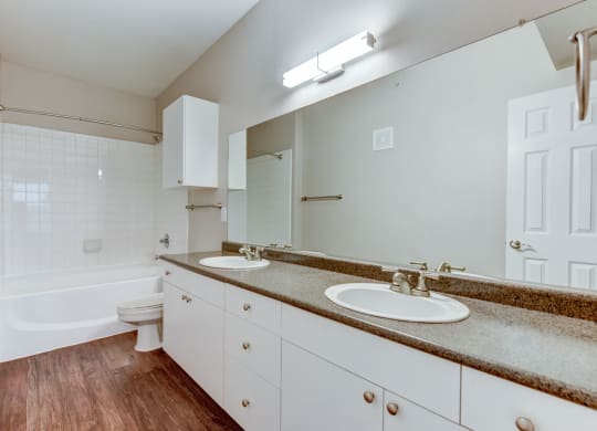 the preserve at ballantyne commons apartment bathroom with two sinks and a bath tub