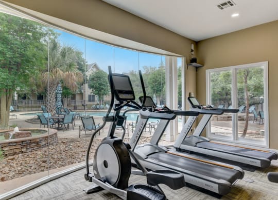 the residence on lamar apartment homes fitness center with gym equipment and large windows