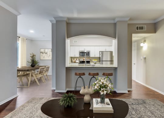 a living room and kitchen with a table and chairs