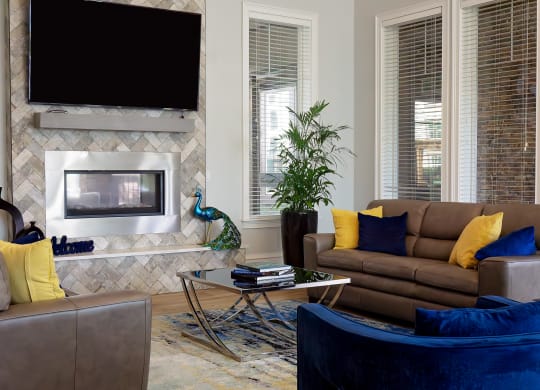 a living room with a fireplace and couches at The Oasis at Moss Park, Orlando