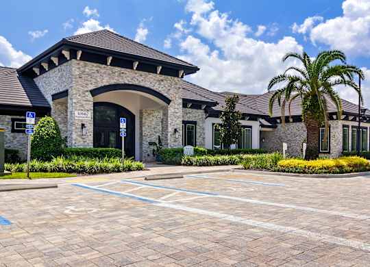 A stone building with a palm tree in front.