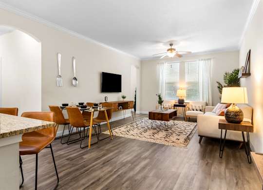 A modern living room with a dining table and chairs.